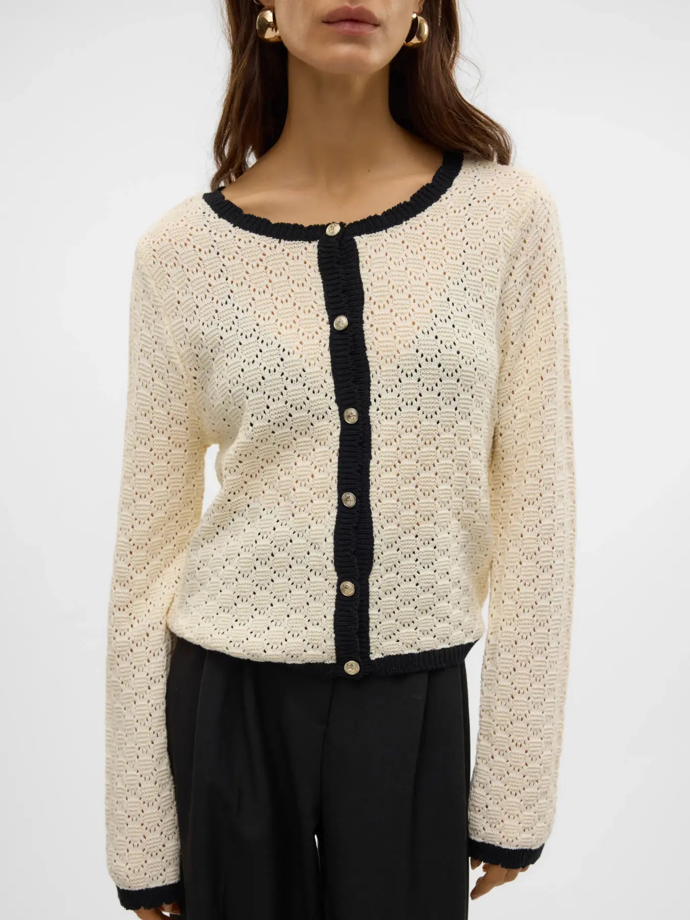 Women's ivory pointelle knit cardigan with black contrast trim, pearl-effect buttons and lightweight breathable fabric for elegant layering and everyday wear.