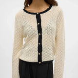 Women's ivory pointelle knit cardigan with black contrast trim, pearl-effect buttons and lightweight breathable fabric for elegant layering and everyday wear.