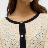 Women's Parisian-inspired pointelle cardigan with long sleeves, round neckline and elegant black trim for business casual and weekend outfits.