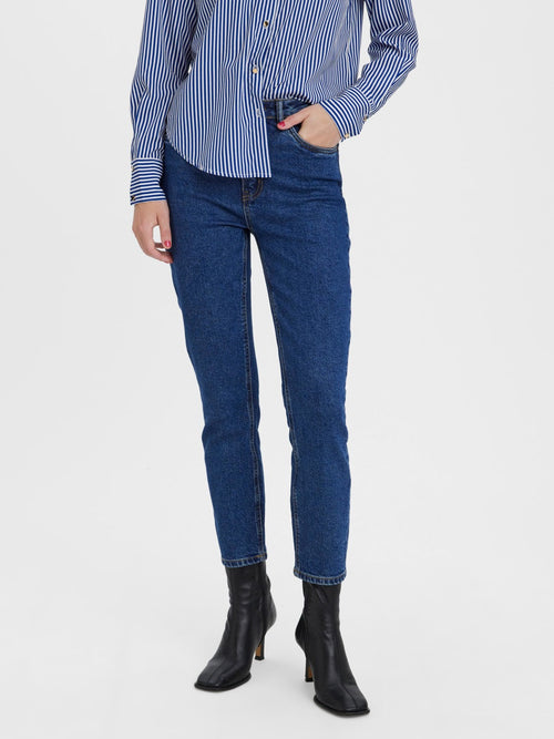 Flattering high-rise jeans in dark indigo denim for casual chic and elevated basics.