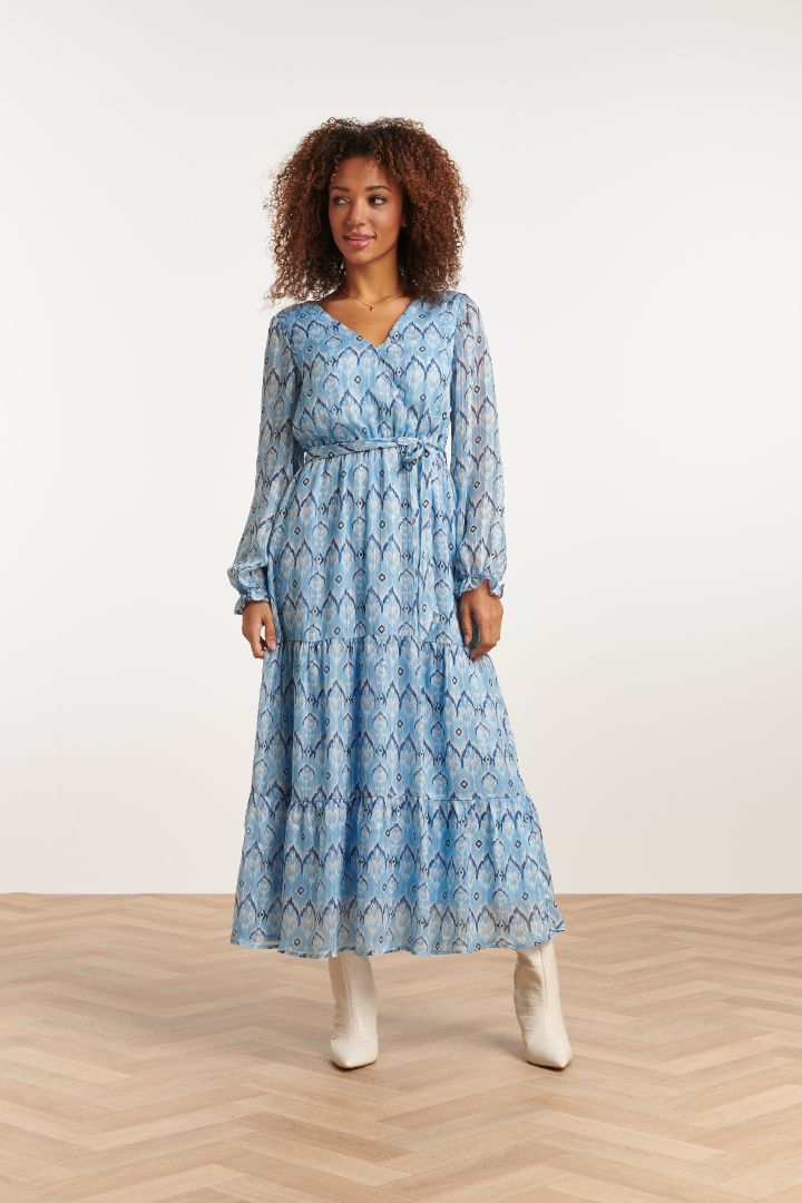 Feminine light blue tiered dress with long sleeves and waist tie for casual chic brunch, vacation, and everyday styling.