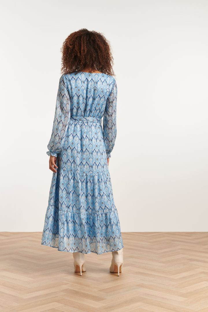 Elegant long sleeve blue maxi dress with soft geometric pattern and flattering cinched waist for timeless feminine style.