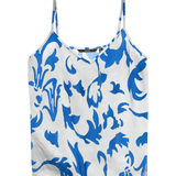 Elegant Mediterranean-inspired singlet with cobalt blue floral scroll print, lightweight fabric and relaxed vacation-ready fit.