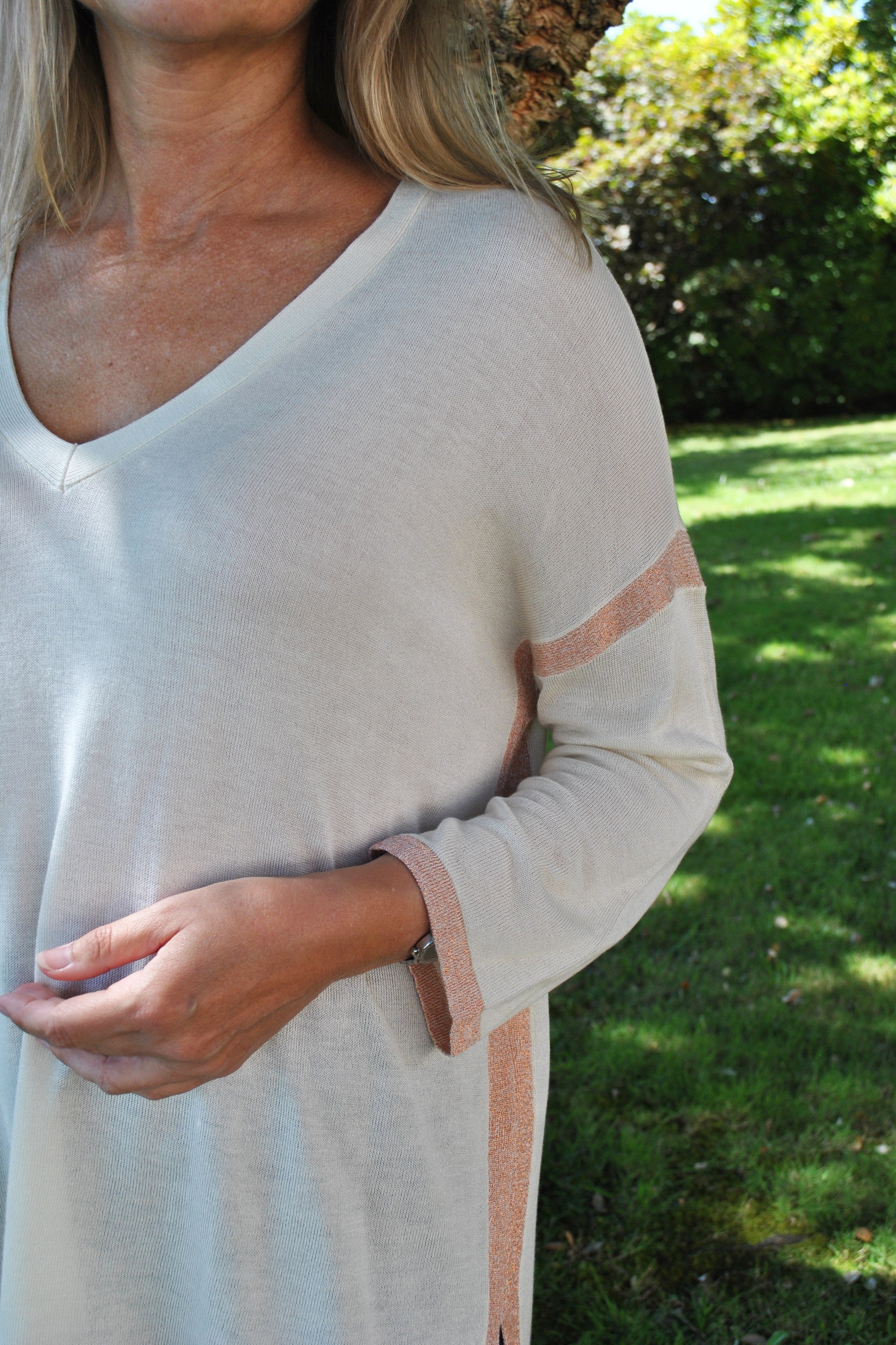 Women’s cozy oversized sweater in cream with subtle pink trim and flowy fit for effortless contemporary fashion.
