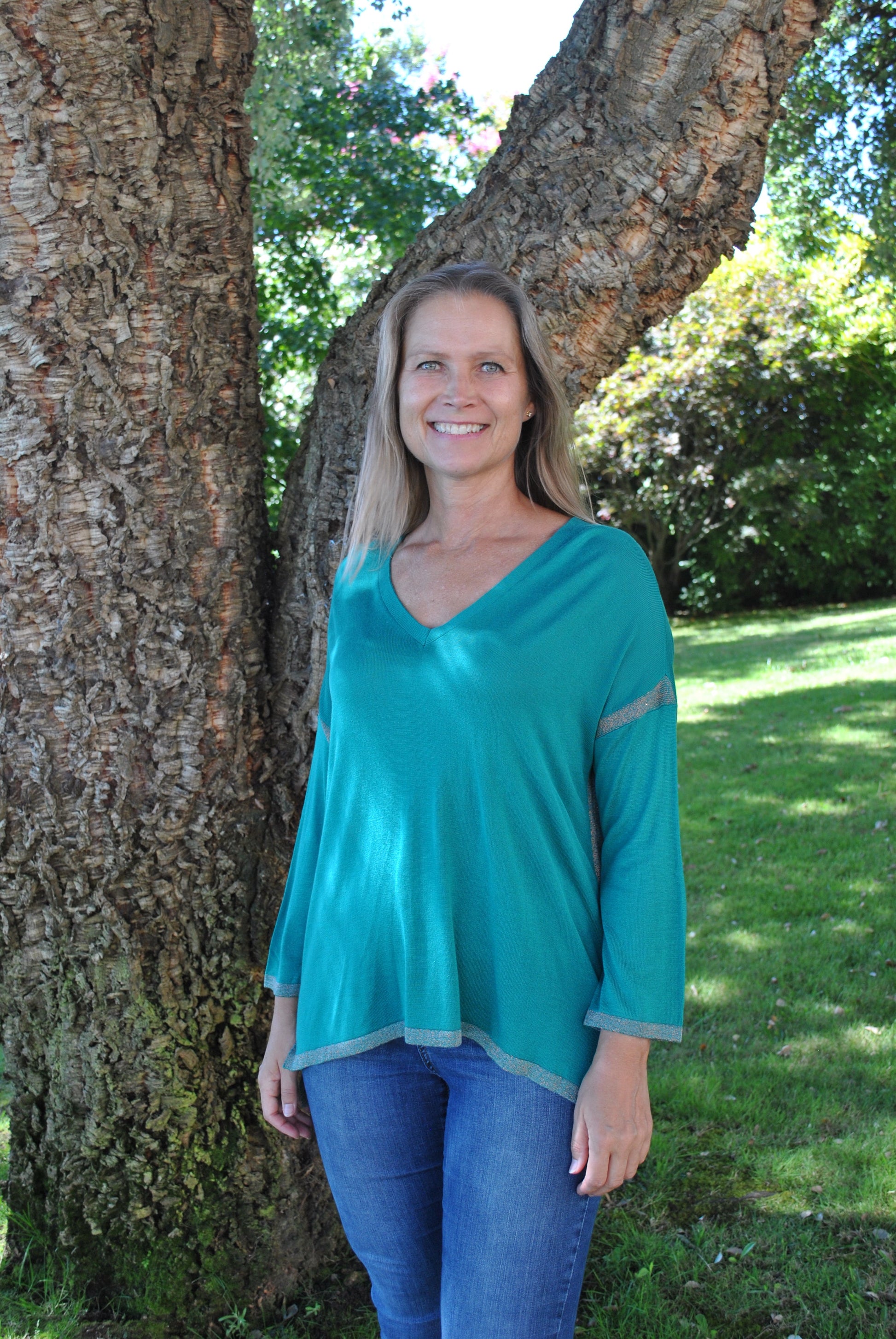 Teal V-neck long sleeve sweater with relaxed oversized fit and feminine trim for modern casual outfits.