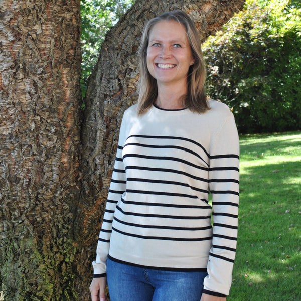 Parisian-style striped sweater with crew neck and long sleeves for classic casual and travel-ready fashion looks.