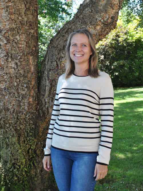 Parisian-style striped sweater with crew neck and long sleeves for classic casual and travel-ready fashion looks.