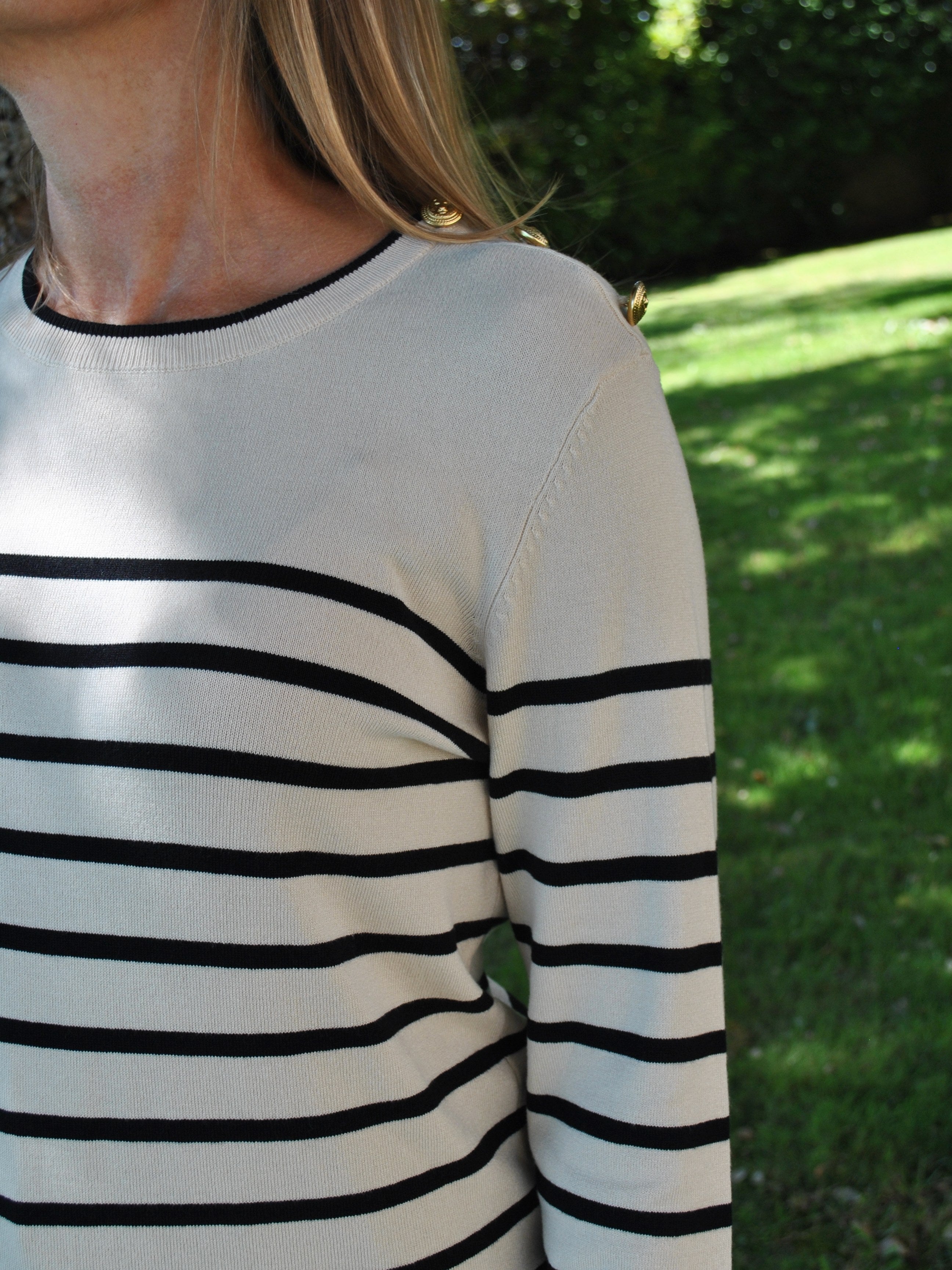 Women’s nautical-inspired striped sweater in cream and black with soft knit fabric and minimalist silhouette.