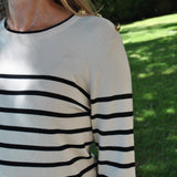 Women’s nautical-inspired striped sweater in cream and black with soft knit fabric and minimalist silhouette.