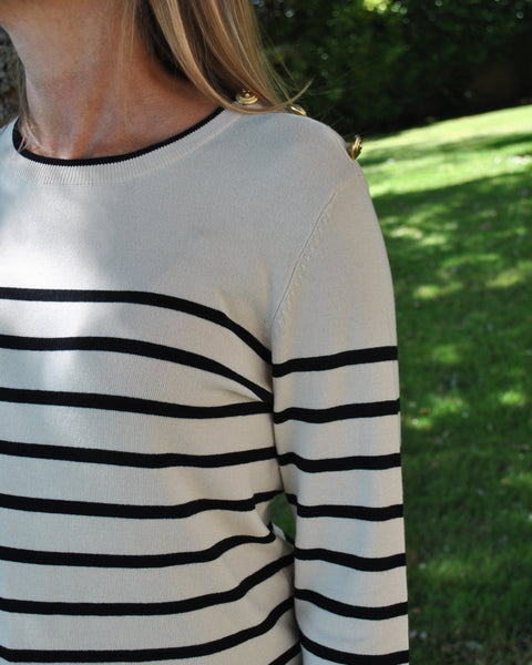 Women’s nautical-inspired striped sweater in cream and black with soft knit fabric and minimalist silhouette.