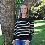 Black and white knit sweater with classic stripe design and minimalist silhouette for timeless women’s boutique fashion.
