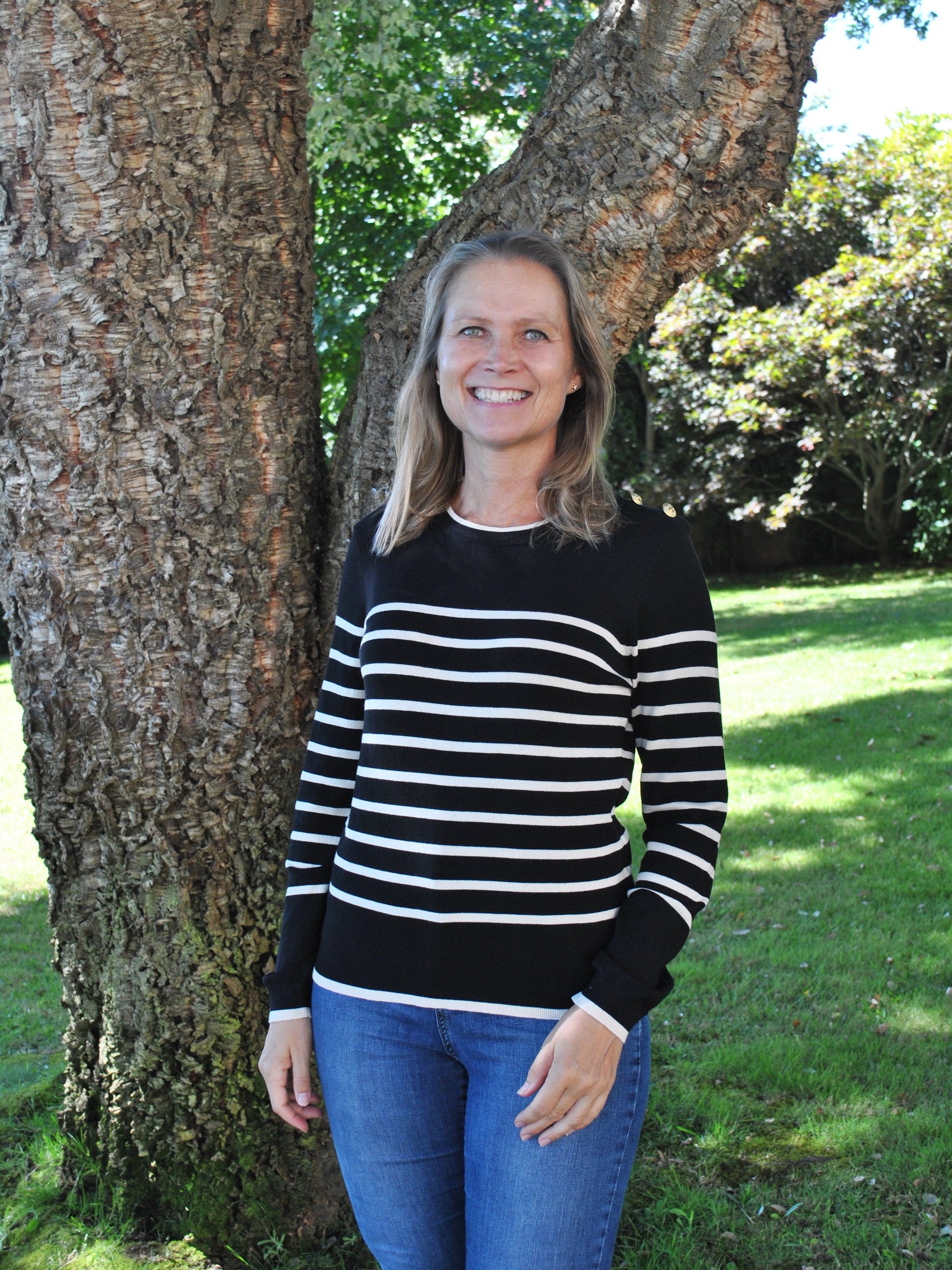 Black and white knit sweater with classic stripe design and minimalist silhouette for timeless women’s boutique fashion.