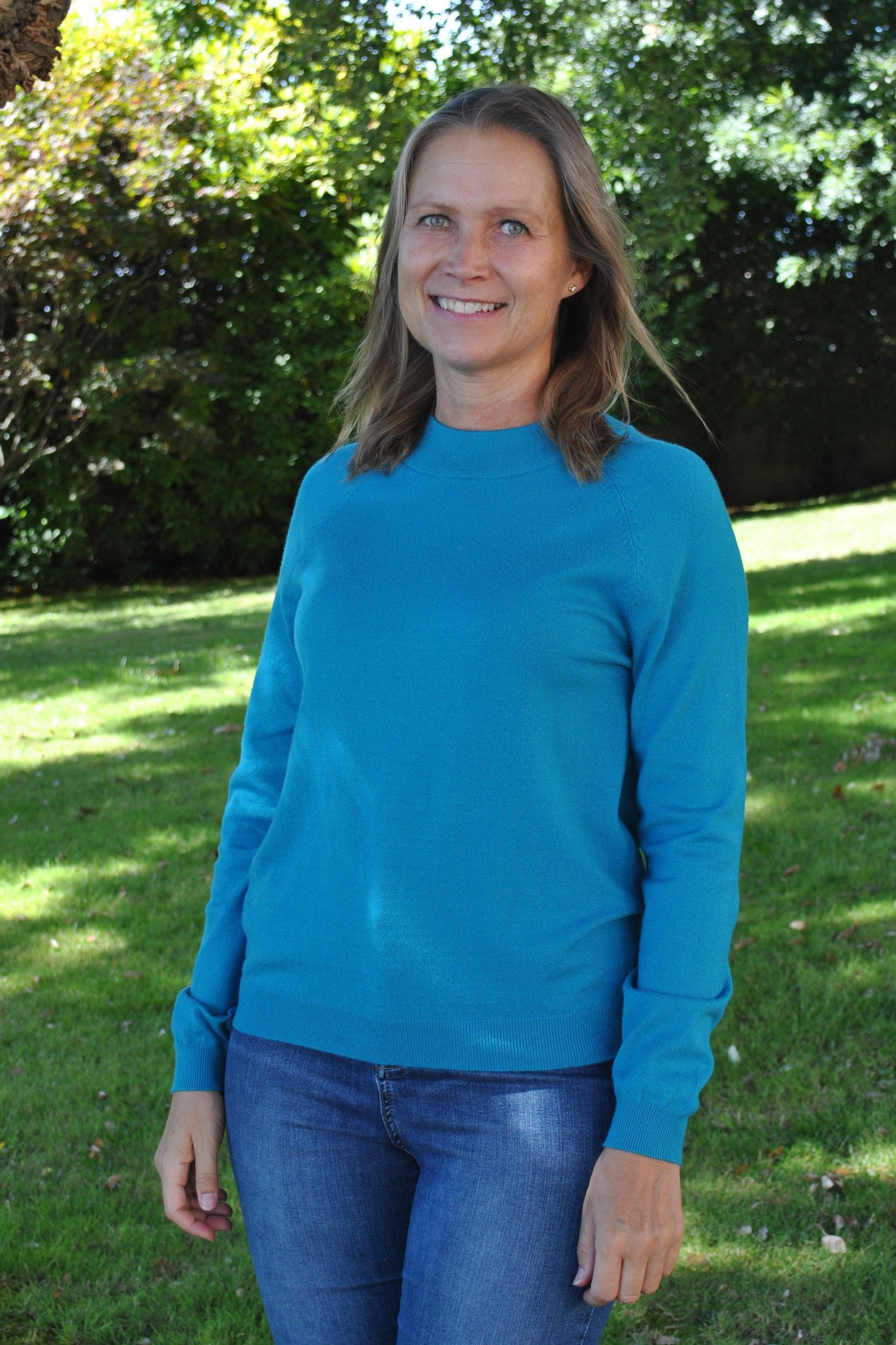 Women's minimalist teal blue sweater with effortless elegance and everyday comfort.