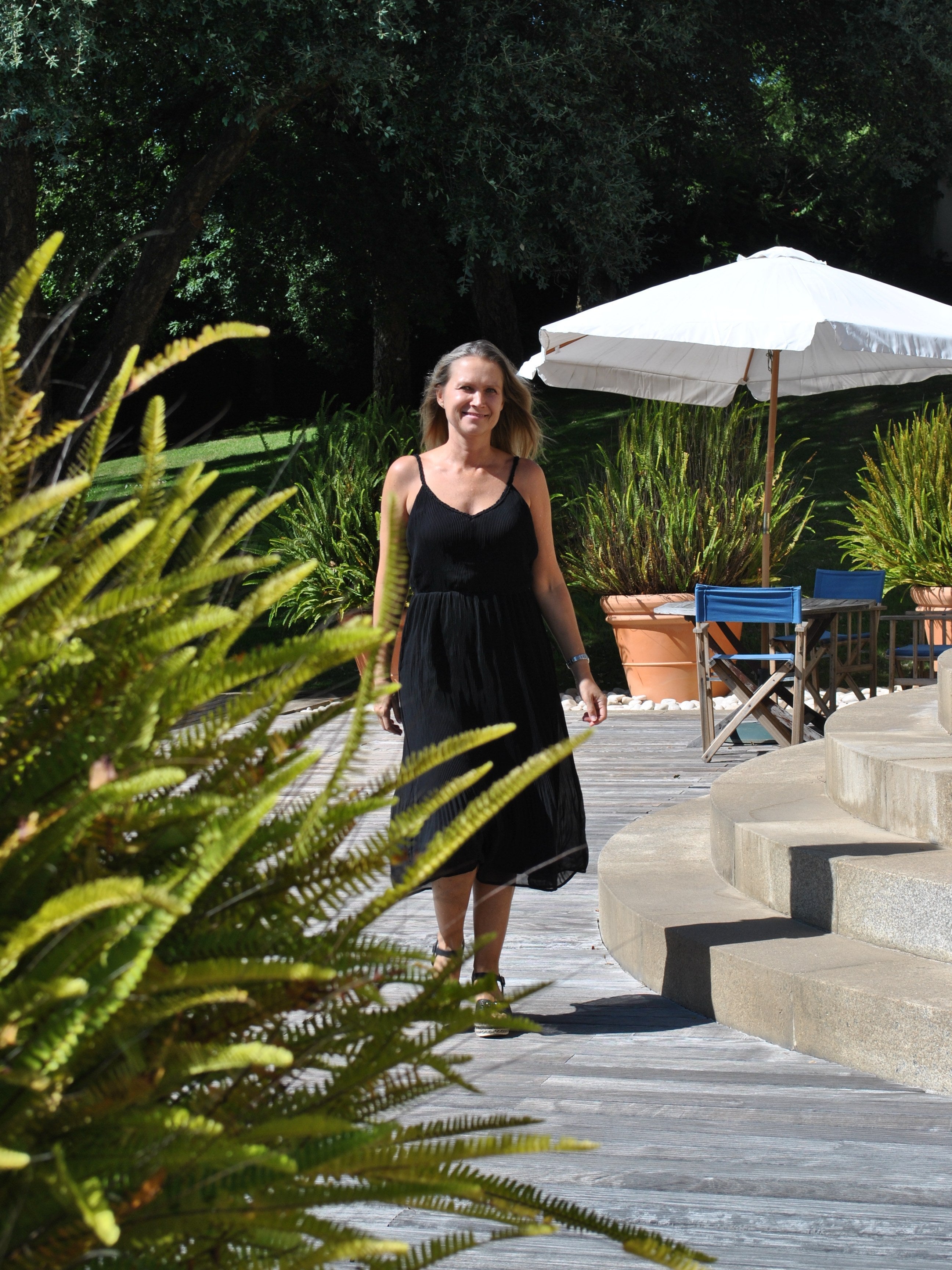Relaxed fit black summer dress featuring soft textured fabric and breezy sleeveless silhouette for resort wear fashion.