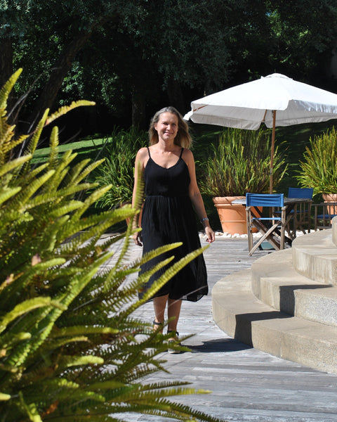 Relaxed fit black summer dress featuring soft textured fabric and breezy sleeveless silhouette for resort wear fashion.