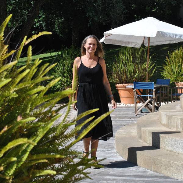 Relaxed fit black summer dress featuring soft textured fabric and breezy sleeveless silhouette for resort wear fashion.