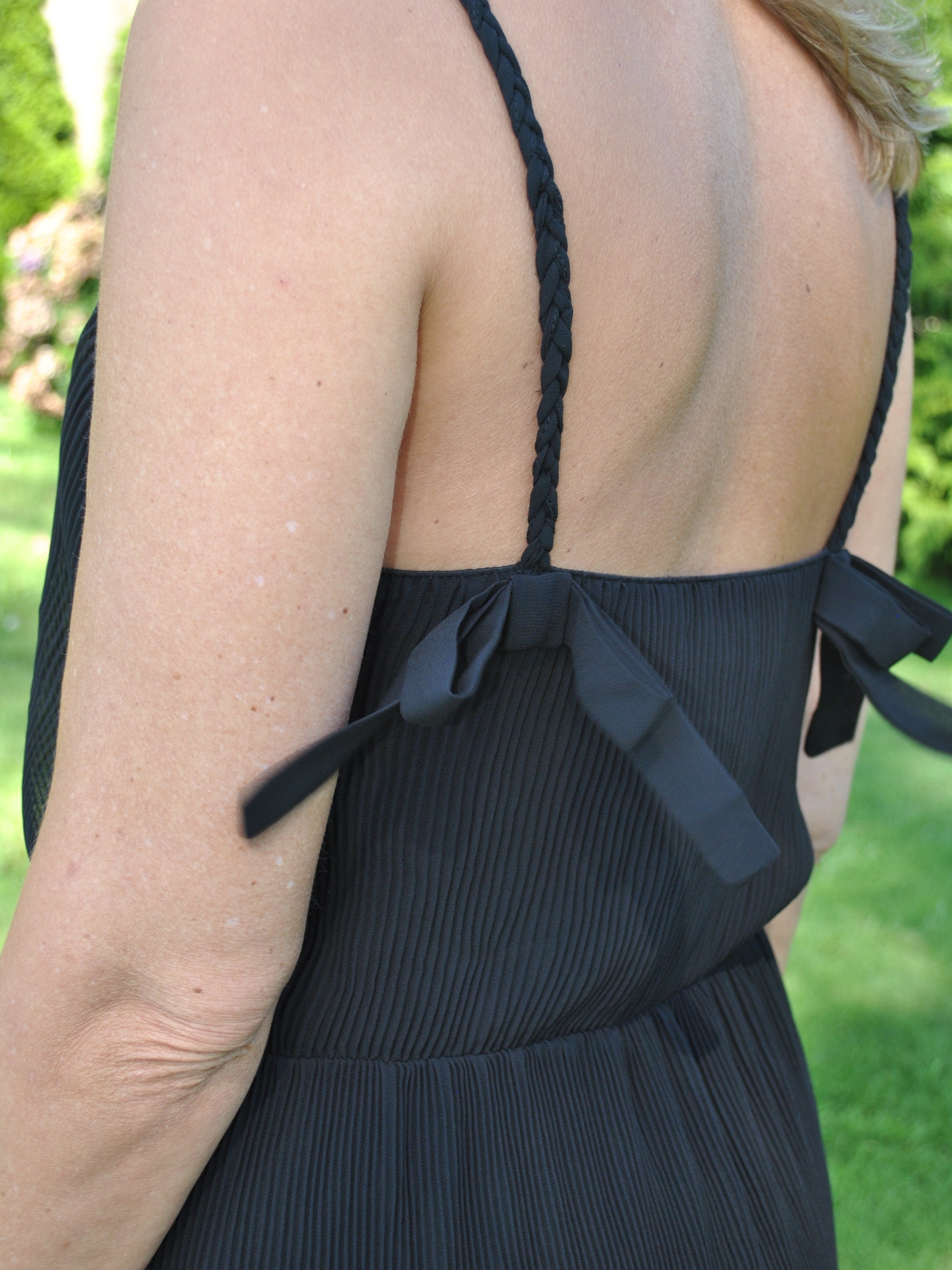 Women’s lightweight black sundress with feminine spaghetti straps with bows and relaxed draped fit for vacation-ready outfits.