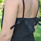 Women’s lightweight black sundress with feminine spaghetti straps with bows and relaxed draped fit for vacation-ready outfits.