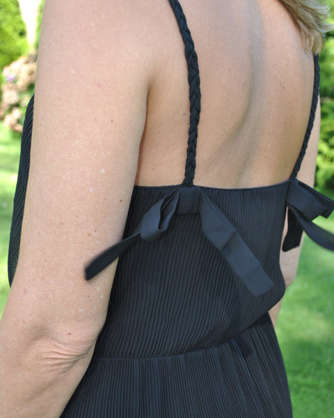 Women’s lightweight black sundress with feminine spaghetti straps with bows and relaxed draped fit for vacation-ready outfits.