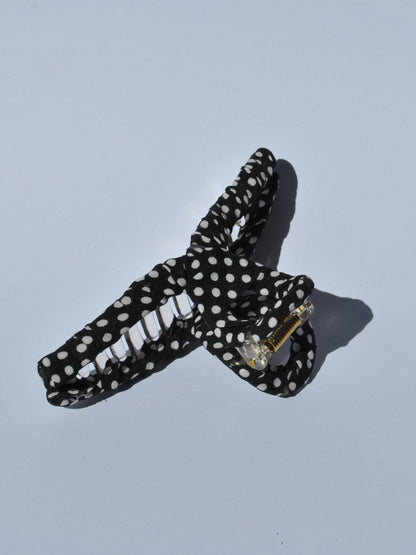 Cute retro-style black polka dot hair claw with lightweight construction and strong grip for casual fashion looks.