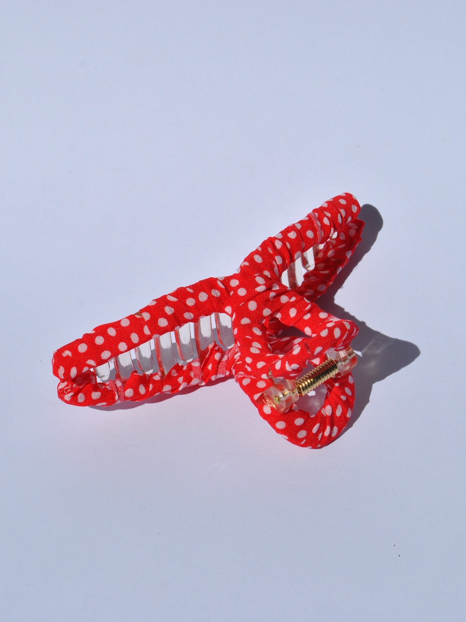 Chic bright orange  and white polka dot hair accessory with lightweight claw clip design for stylish everyday updos.