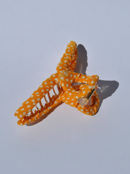 Yellow with white polka dot claw hair clip with soft fabric wrap and oversized grip design for cute everyday hairstyles.