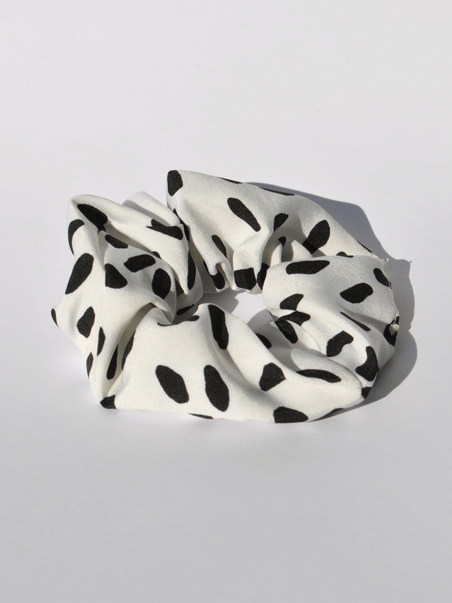 Modern black and white hair tie accessory ideal for casual, work, and weekend looks.