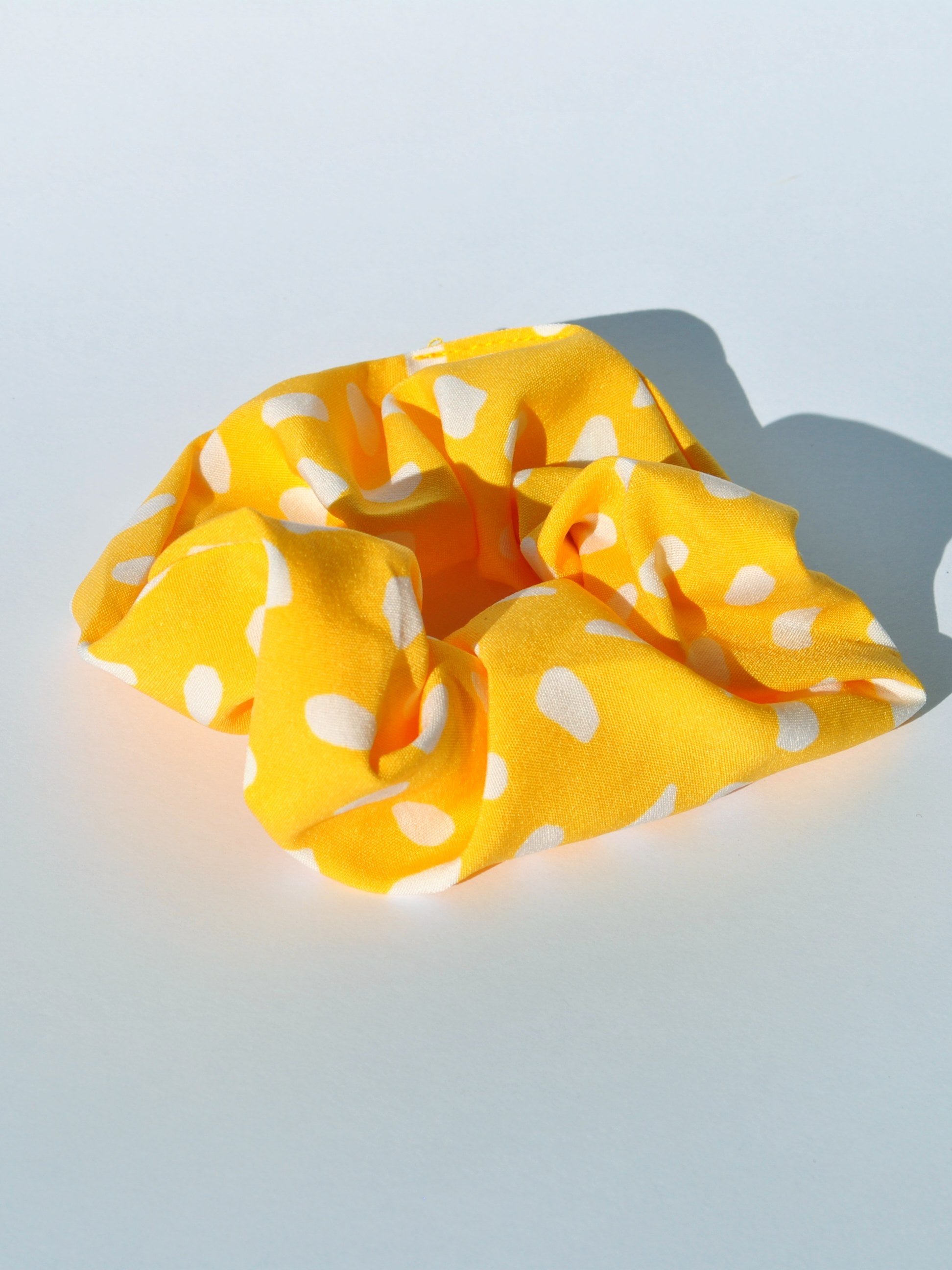 Women's soft fabric hair accessory with trendy dot print and secure elastic hold.