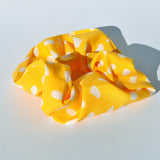Women's soft fabric hair accessory with trendy dot print and secure elastic hold.