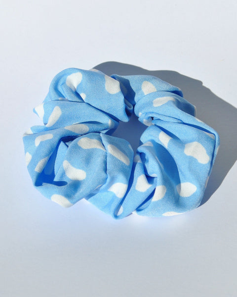 Stylish blue polkadot printed hair scrunchie perfect for creating chic ponytails, messy buns, and updos.