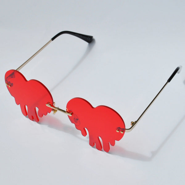 Unique red dripping heart sunglasses with rimless tinted lenses and gold metal frame.