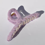 Fabric-wrapped oversized claw clip for thick hair and effortless styling.