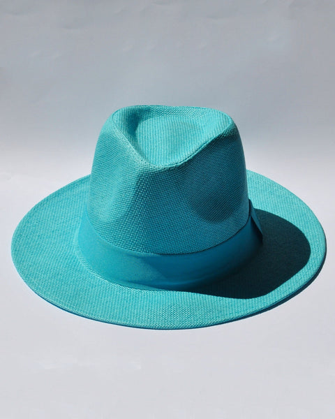 Women's turquoise wide brim fedora hat with woven texture and matching ribbon band for summer vacations.