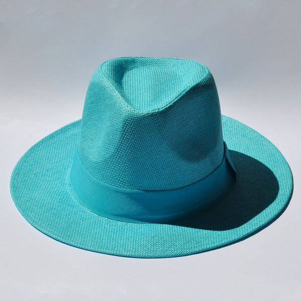 Women's turquoise wide brim fedora hat with woven texture and matching ribbon band for summer vacations.