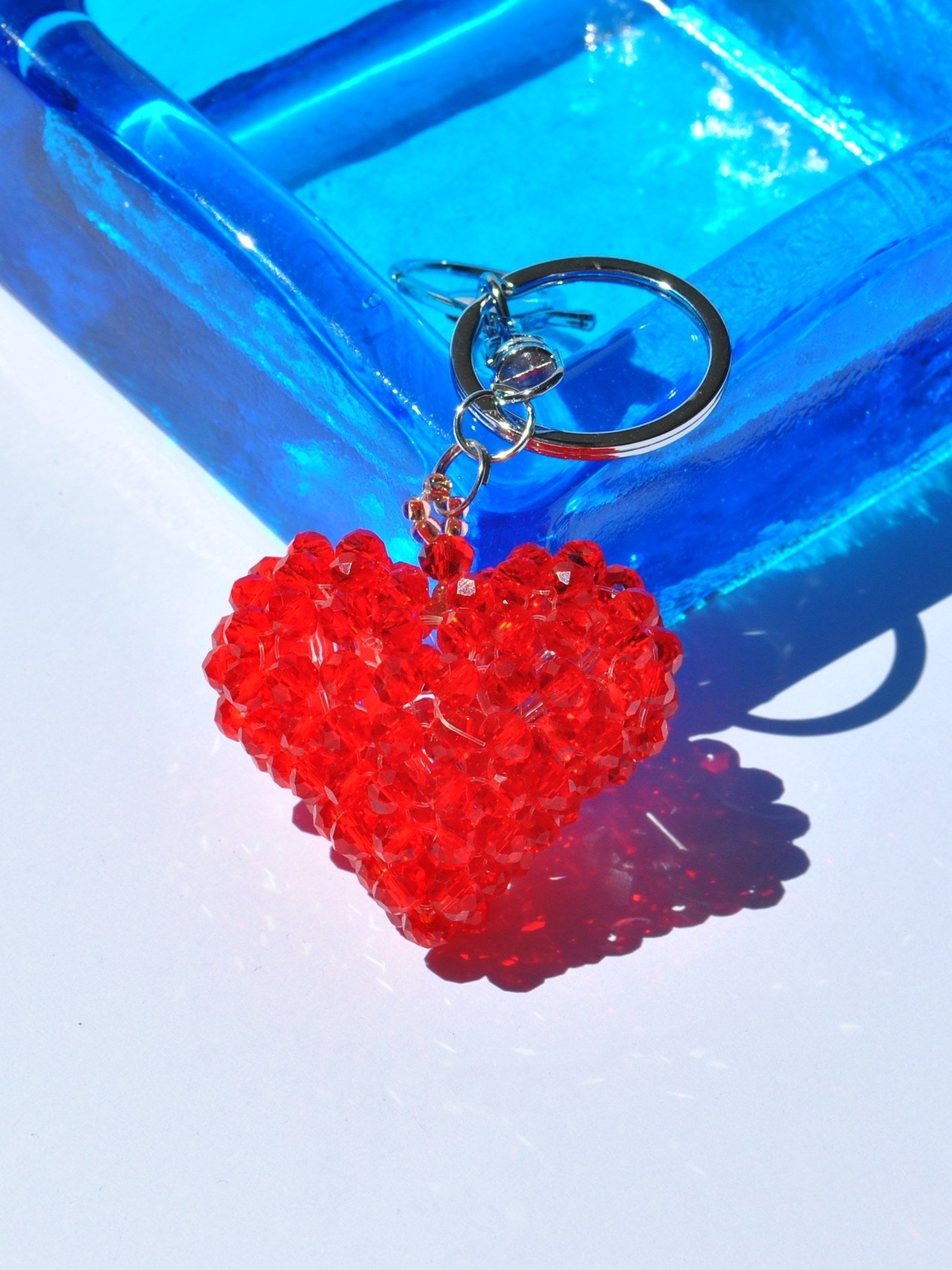 Sparkling faceted red heart keychain accessory for handbags, backpacks, and keys.