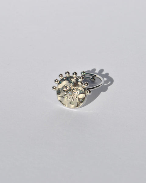 Contemporary silver statement ring with celestial sun engraving and modern adjustable fit for everyday fashion looks.