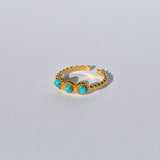 Women’s adjustable gold beaded ring featuring turquoise gemstone accents and minimalist stackable fashion jewelry design.
