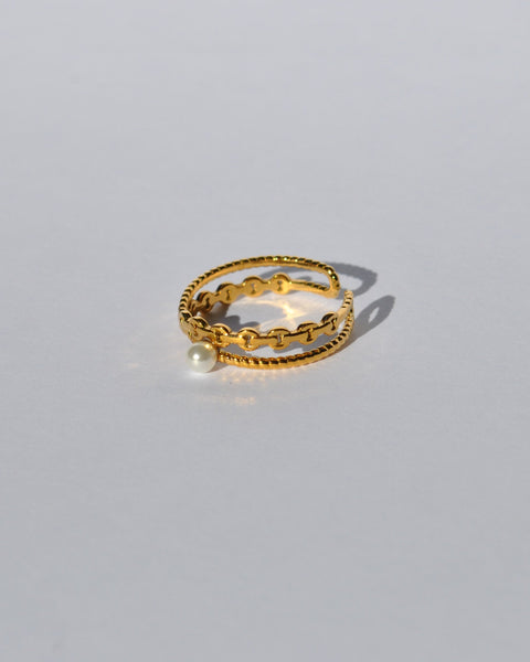 Women’s gold wraparound ring with textured detailing and elegant pearl centerpiece for stylish day-to-night outfits.