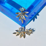 Glamorous crystal dangle earrings featuring modern botanical design and lightweight statement silhouette.