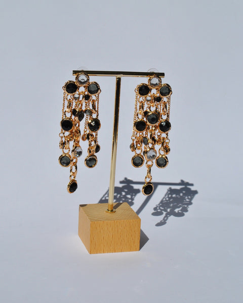 Trendy statement dangle earrings with black jewel detailing and glamorous gold finish for upscale party wear.