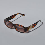 Trendy tortoiseshell sunglasses featuring chunky square frames and designer-inspired gold temple accents for statement styling.