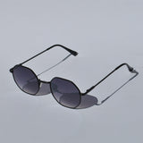 Modern geometric sunglasses for women with slim black metal frames and trendy oversized hexagon lens shape.