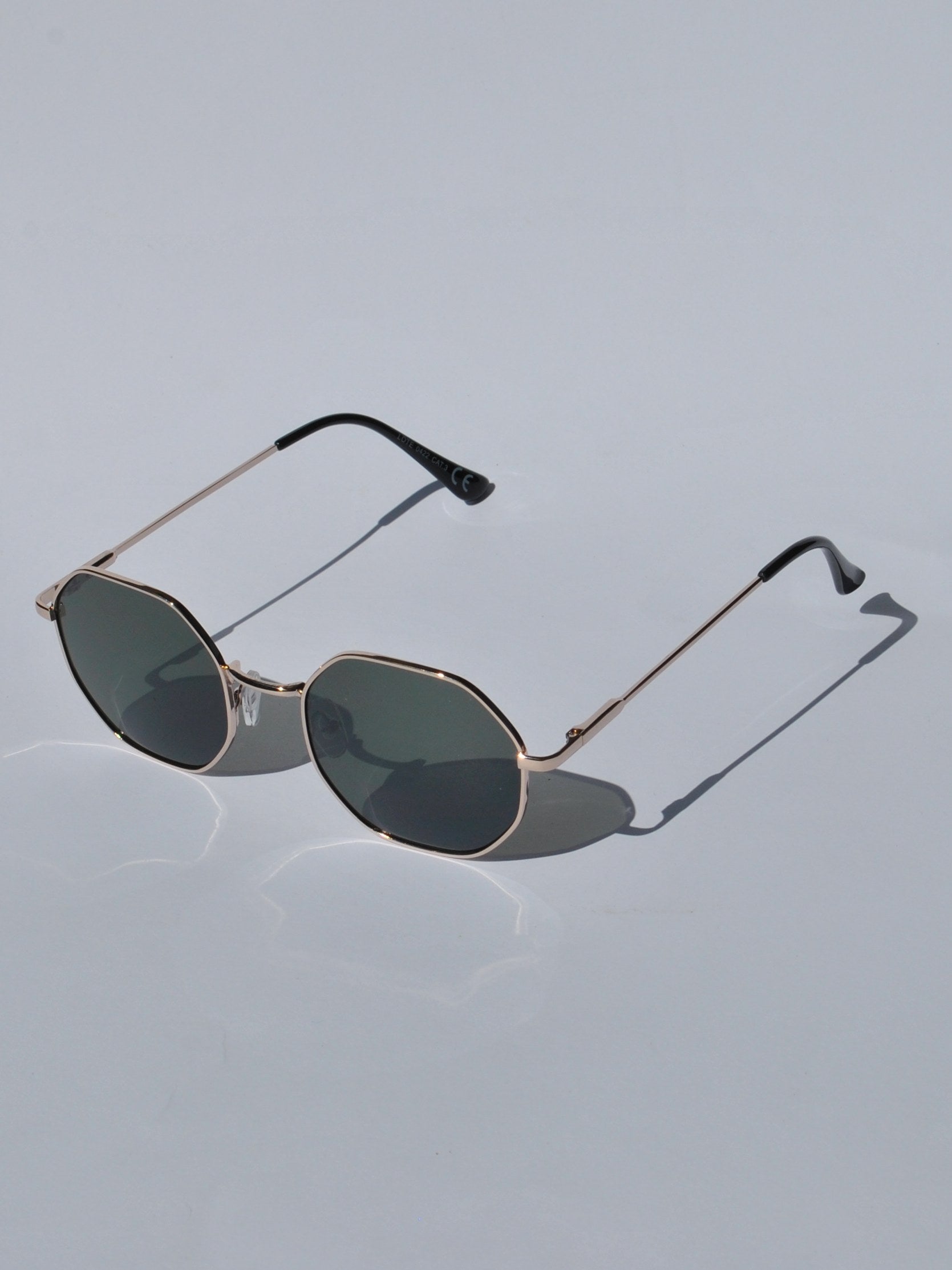 Women’s lightweight gold sunglasses with angular hexagon silhouette and UV400 gradient lenses for timeless stylish looks.