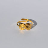 Chic gold open ring featuring a modern knot motif and polished metallic finish for trendy everyday jewelry looks.