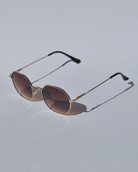 Modern geometric sunglasses for women with slim gold metal frames and trendy oversized hexagon lens shape.