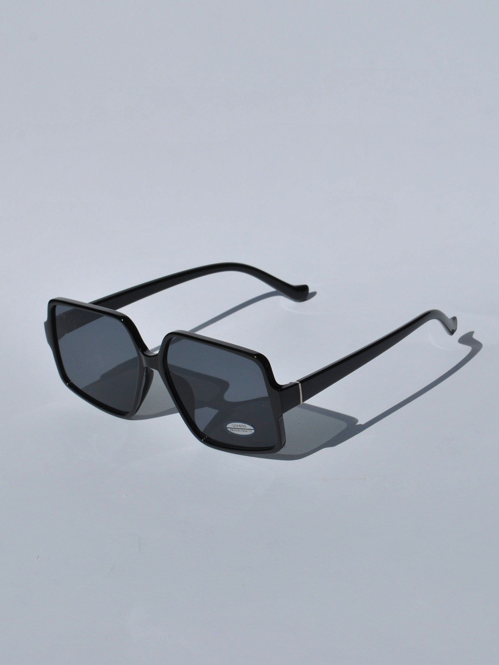 Women’s bold black sunglasses with oversized square frames and contemporary designer-inspired look for summer fashion.