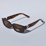 Stylish rectangular tortoise sunglasses with dark tinted lenses and retro 90s aesthetic for casual and vacation wear.