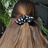 Trendy black polkadot fabric scrunchie with white polka dot print for effortless everyday styling.