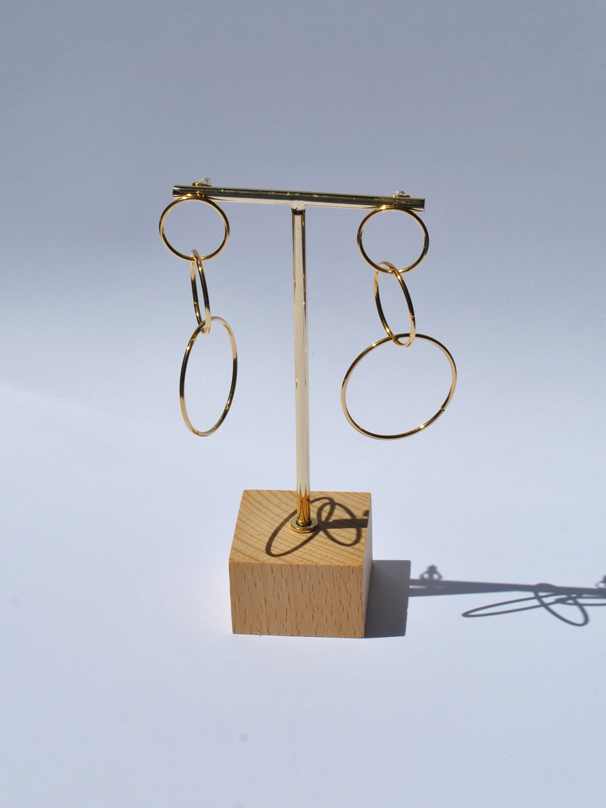 Gold fashion earrings featuring oversized open hoops and trendy modern statement jewelry aesthetic.