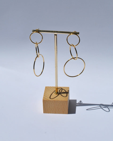 Gold fashion earrings featuring oversized open hoops and trendy modern statement jewelry aesthetic.